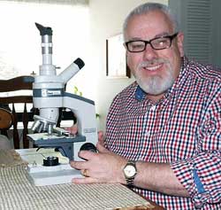 Frank DeFreitas at his microscope