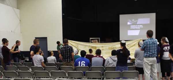 students examining a full-sized replica of the Shroud of Turin