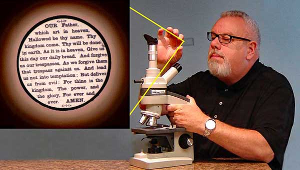 The author examines a nineteenth century microphotograph through his microscope.