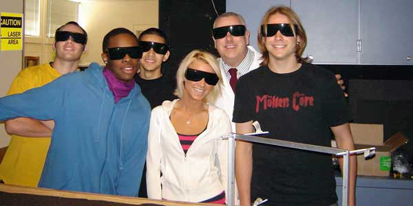 Frank DeFreitas with students in his laser and holography workshop program.
