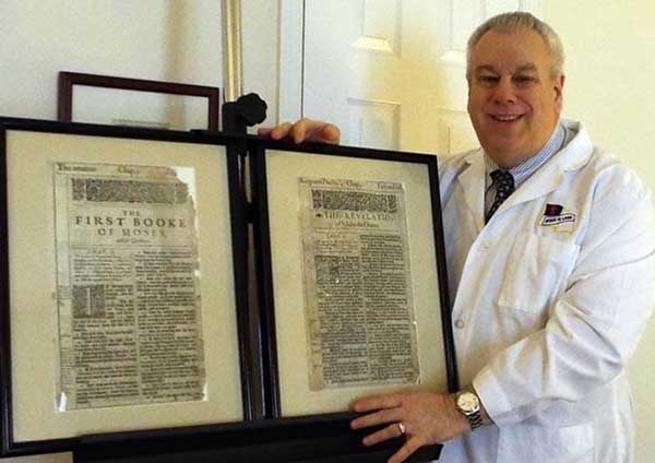 Frank DeFreitas displays two pages from a first-edition 1611 King James Bible.