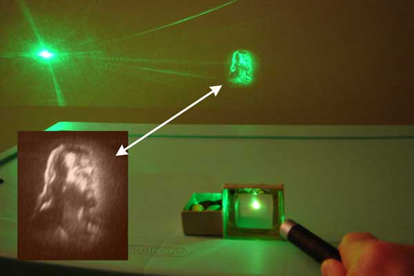 photograph of laser hologram projection of face of Christ.