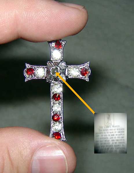 An early 20th century jeweled Stanhope cross showing the Lords Prayer through a lens.